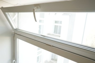 white glass pane open for ventilation on a white background close-up
