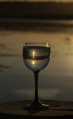 the sunset in the glass near the river