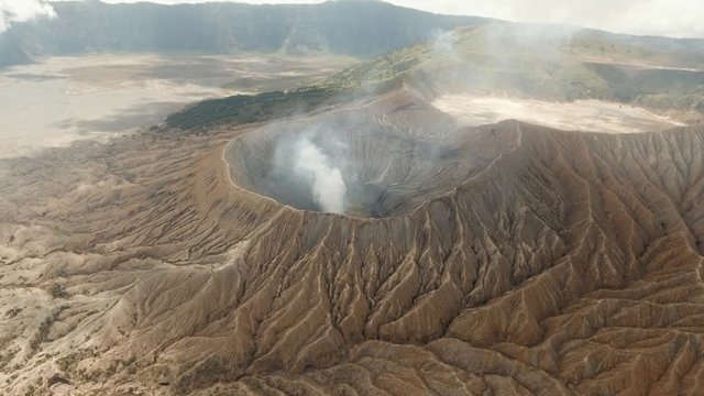 Mountain Bromo active volcano crater in East Jawa, Indonesia. Aerial view of volcano crater Mount Gunung Bromo is an active volcano,Tengger Semeru National Park. 4K video. Aerial footage.