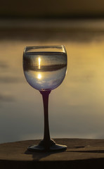 sunset reflection at the glass of water