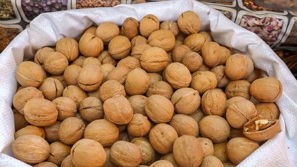 Walnuts in a shell.Fresh harvest of nuts collected in a bag