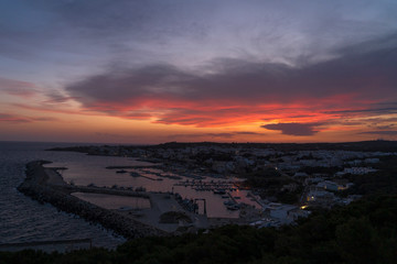 Fototapeta premium Sunset at Santa Maria di Leuca. Santa Maria di Leuca, Colonna Corinzia - Salento, Lecce, Apulia, Italy . Religious symbol, crucifix, cross - Immagine