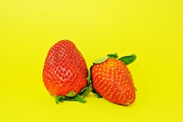 Fresh strawberries on a yellow background