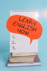 Writing note showing Learn English Now. Business concept for gain or acquire knowledge and skill of...