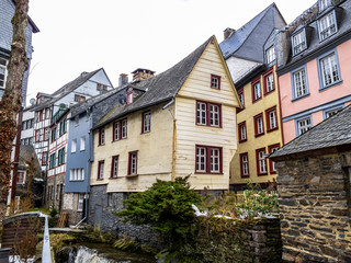 Fototapeta na wymiar Preserved old half-timbered buildings along the Rur River in Monschau downtown, Germany