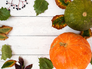 Autumn leaves and pumpkins on an old wooden white background. Background with copy space. Top view, flat plan.