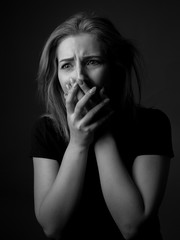 Scared and sad young woman. Black and white