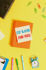 Word writing text Stop Blaming Other People. Business photo showcasing Do not make excuses assume your faults guilt Flat lay above table with copy space paper clips clock and pencils