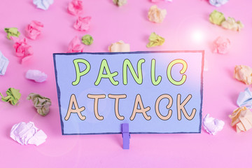 Writing note showing Panic Attack. Business concept for sudden periods of intense fear that may include palpitations Colored crumpled papers empty reminder pink floor background clothespin