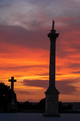 Obraz premium Sunset at Santa Maria di Leuca. Santa Maria di Leuca, Colonna Corinzia - Salento, Lecce, Apulia, Italy . Religious symbol, crucifix, cross - Immagine