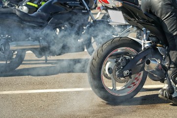 Motorbike burnout, Biker on a motorcycle drifts in smoke, burns the tire on a motorcycle