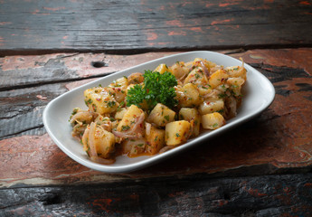 Potato salad isolated on rustic wooden table