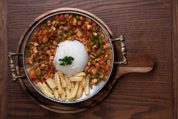 Turkish food lamb meat saute, sac kavurma with rice and french fries isolated on rustic wooden table