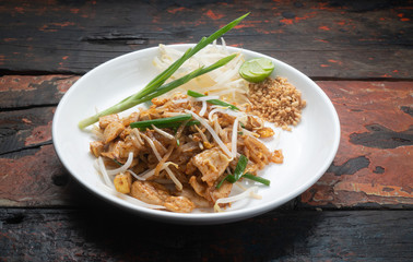 Top view Thai food Pad Thai chicken isolated on rustic wooden table