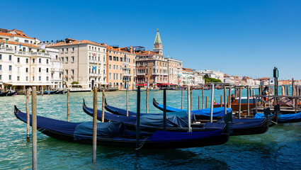 Fototapeta premium Venetian gondolas moored in Grand Canal