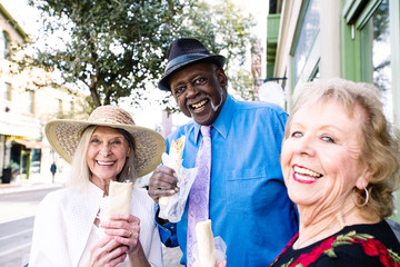 Smiling Senior Trio Eating Tasty Mexican Street Food