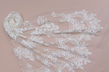 Texture lace fabric. lace on white background studio. thin fabric made of yarn or thread. a background image of ivory-colored lace cloth. White lace on beige background.