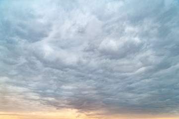 Dark clouds. Rainy windy sky in the evening at sunset.