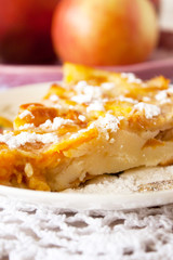Homemade fruit apple apricot peach pie on white crochet napkin on white rustic table background