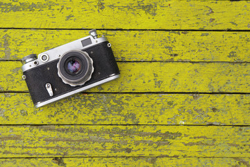 The film camera lies on a yellow table
