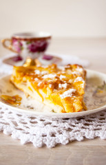 Homemade fruit apple apricot peach pie on white crochet napkin on white rustic table background