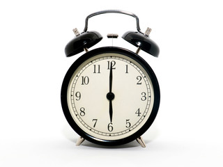 Old-style alarm clock, black and white, it's six o'clock.