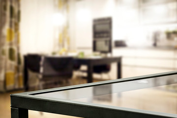 Glass coffee table of free space and kitchen interior 