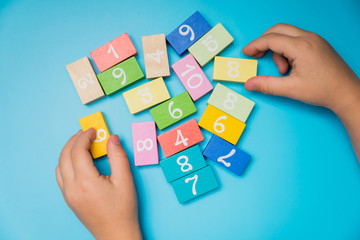 colored cubes with numbers hands