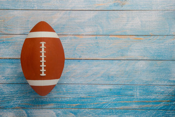 American football ball on wooden background