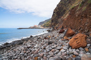 Fototapeta na wymiar Steep rocky coast with occational rockfalls at Paul do Mar, Madeira
