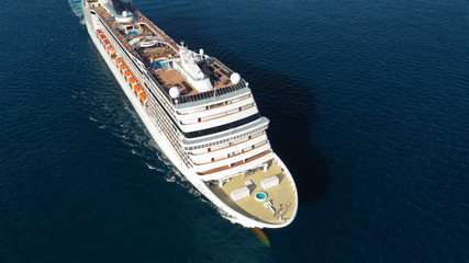 Aerial top view photo of huge cruise liner with pools and outdoor facilities cruising the Atlantic...