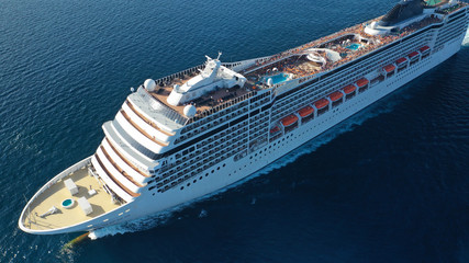Aerial top view photo of huge cruise liner with pools and outdoor facilities cruising the Atlantic...