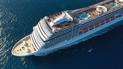 Aerial top view photo of huge cruise liner with pools and outdoor facilities cruising the Atlantic...