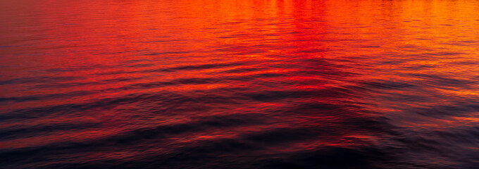 Reflections of a beautiful orange sunset on water - Powered by Adobe
