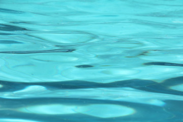 Blue pool water reflecting sun rippled details.surface of blue pool, bottom of water in swimming pool