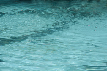 Blue pool water reflecting sun rippled details.surface of blue pool, bottom of water in swimming pool
