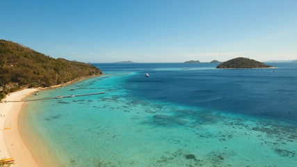 Aerial view of tropical beach with beach,resort, hotels. Philippines. Beautiful tropical island with sand beach, palm trees. Tropical landscape: beach with palm trees. Seascape: Ocean, sea. Travel