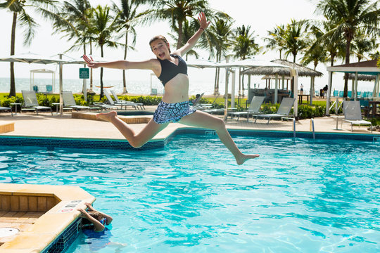 13 year old girl leaping into pool