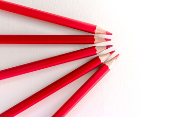 Set of red color pencil on white paper background