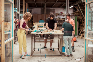 Full length of carpenters working in workshop