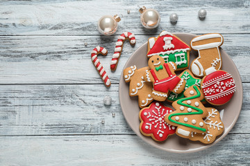 Flat lay composition with tasty homemade Christmas cookies on white wooden table, space for text