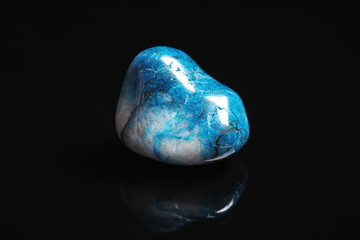 Beautiful blue shattuckite gemstone on black background