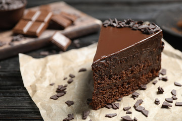 Delicious fresh chocolate cake on wooden table, closeup