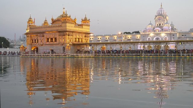a medium view of the famous golden temple at sunset in amritsar, india