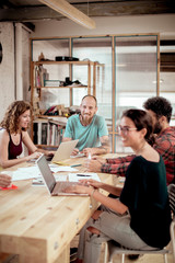 Smiling carpenters during meeting in office at workshop