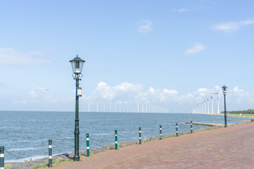 'IJsselmeer' (lake IJssel) with the beach and windmils at the city of URK, NLD