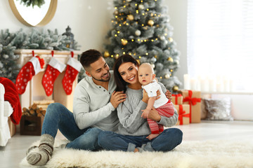 Happy family with cute baby at home. Christmas celebration