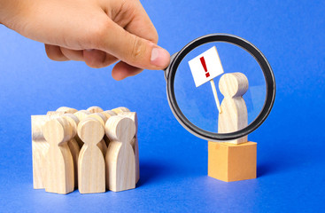 A magnifying glass looks at a person with a poster exclamation mark is on the box and draws the...