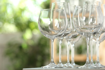 Empty glasses on table against blurred background