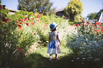 toddler girl playing in  summer   garden